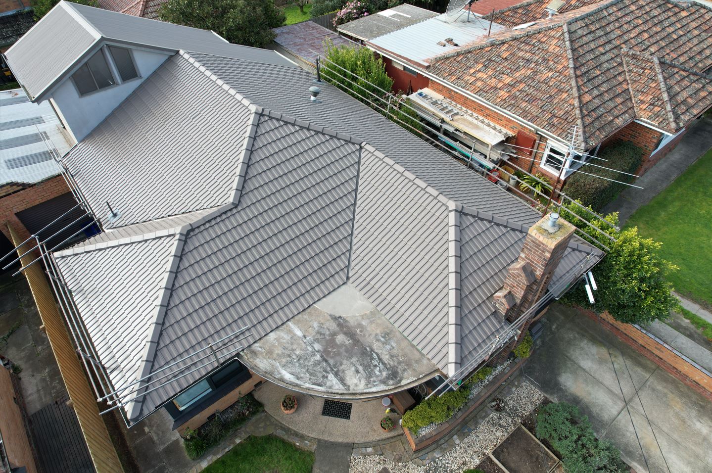 Aerial view of tiled and metal roofs on a Melbourne property